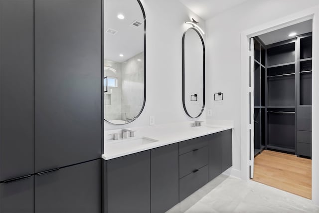 bathroom featuring a shower, vanity, and hardwood / wood-style flooring