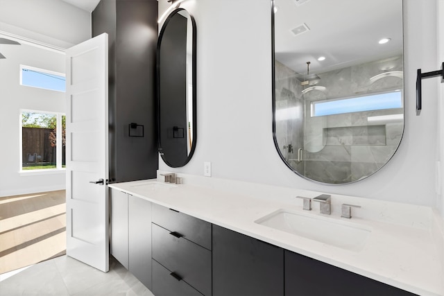 bathroom with tile patterned floors, a shower with door, and vanity