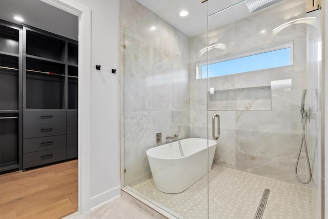 bathroom featuring separate shower and tub and hardwood / wood-style floors