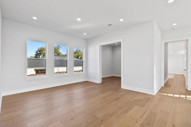 empty room with light hardwood / wood-style flooring