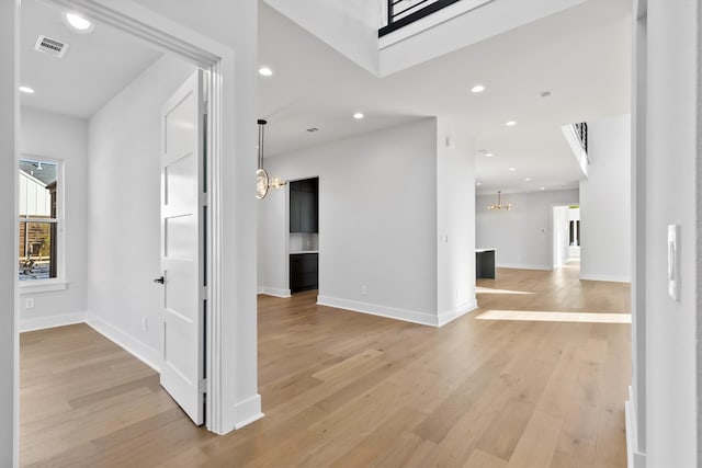 foyer featuring a notable chandelier and light hardwood / wood-style floors