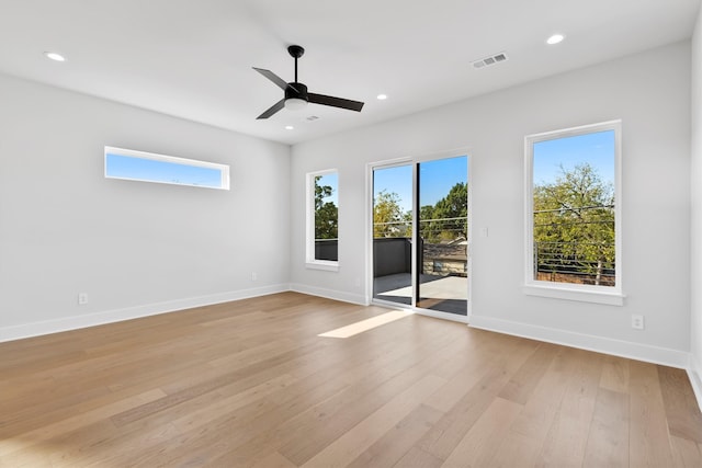 empty room featuring ceiling fan and light wood-type flooring