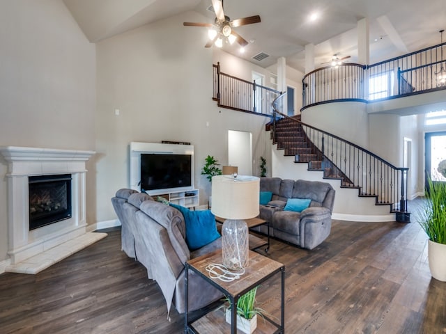 living room featuring dark hardwood / wood-style flooring, high vaulted ceiling, and ceiling fan