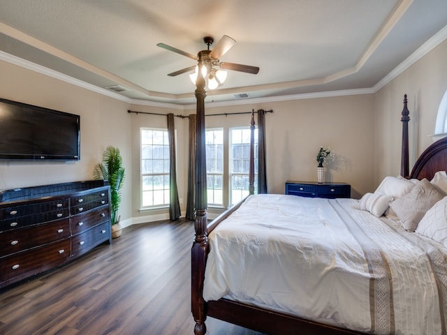 bedroom featuring ceiling fan, a raised ceiling, dark wood-type flooring, and crown molding