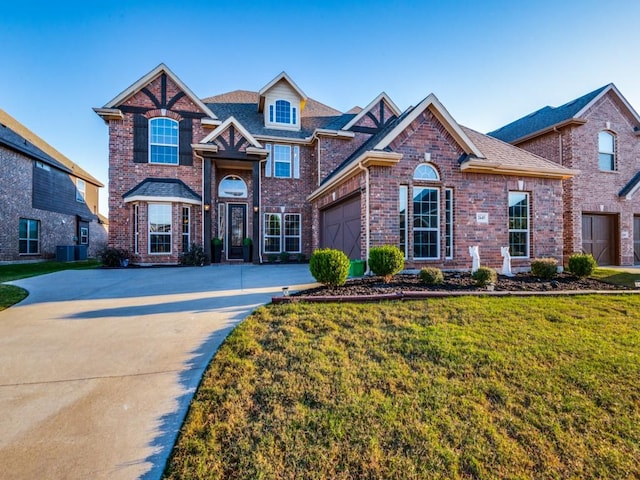 view of property with a front yard and a garage