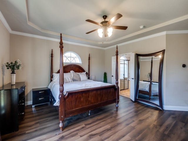 bedroom with ceiling fan, a raised ceiling, ornamental molding, and dark wood-type flooring