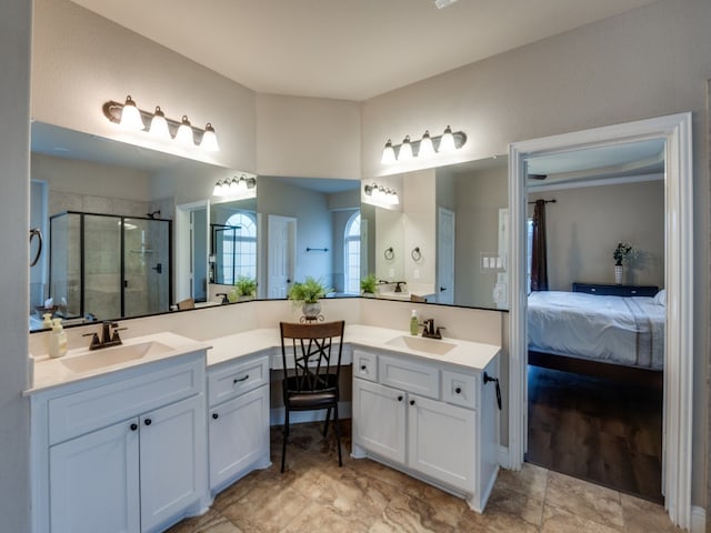 bathroom with vanity and a shower with shower door