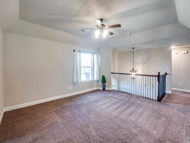 carpeted empty room with ceiling fan, a textured ceiling, and a tray ceiling