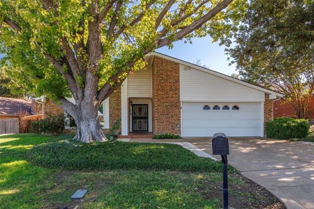 view of front of house featuring a garage and a front lawn