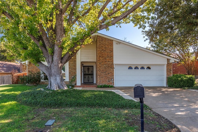 view of front of house featuring a garage and a front lawn