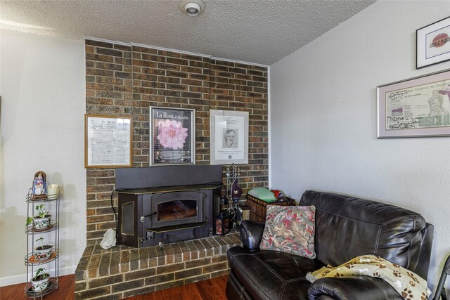 living area with dark wood-type flooring and a textured ceiling