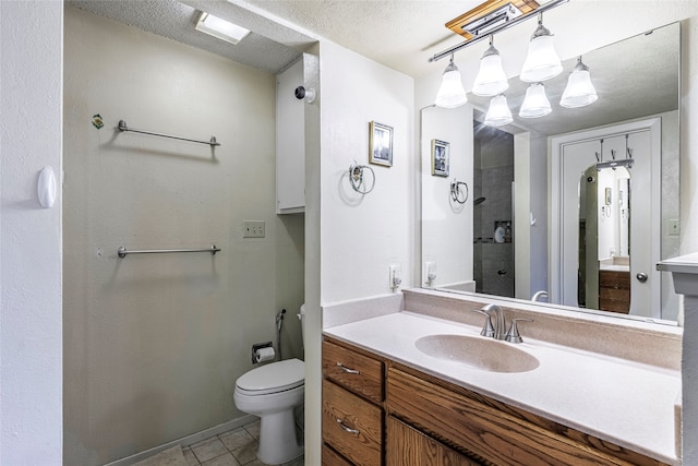 bathroom with walk in shower, vanity, a textured ceiling, tile patterned flooring, and toilet