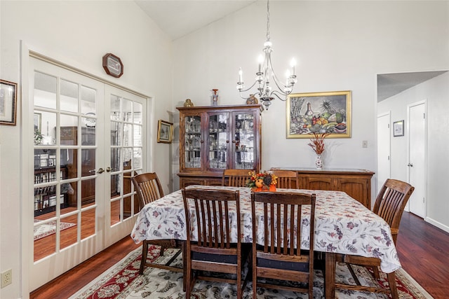 dining room with french doors, high vaulted ceiling, and dark wood-type flooring