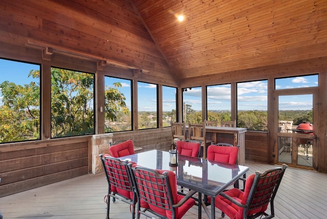 sunroom featuring wooden ceiling, a healthy amount of sunlight, and vaulted ceiling