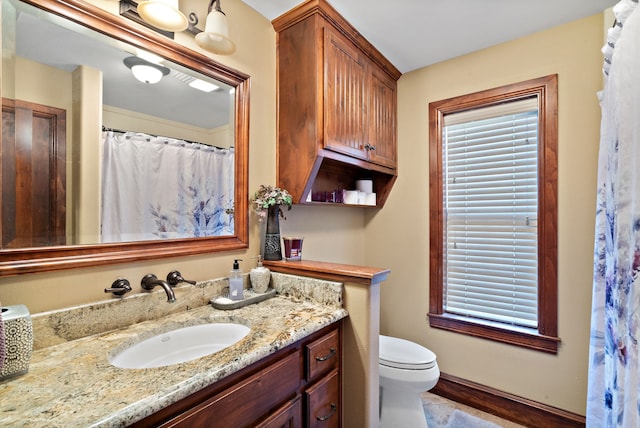 bathroom with hardwood / wood-style floors, vanity, and toilet