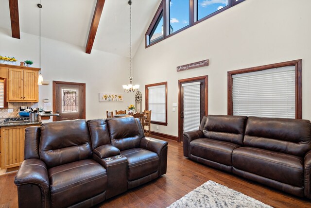 living room featuring dark hardwood / wood-style floors, beam ceiling, high vaulted ceiling, and an inviting chandelier