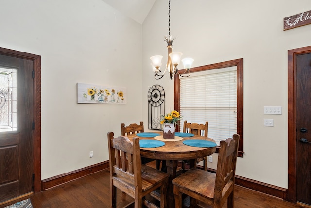 dining space featuring a chandelier, dark hardwood / wood-style floors, and vaulted ceiling