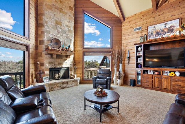 living room featuring carpet flooring, beam ceiling, high vaulted ceiling, and wooden walls