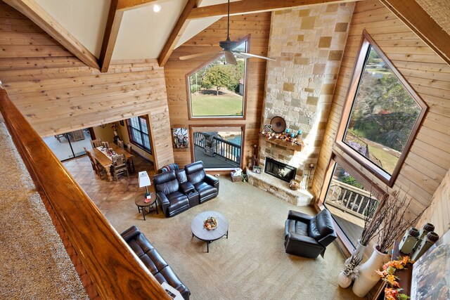 carpeted living room featuring a healthy amount of sunlight and wooden walls