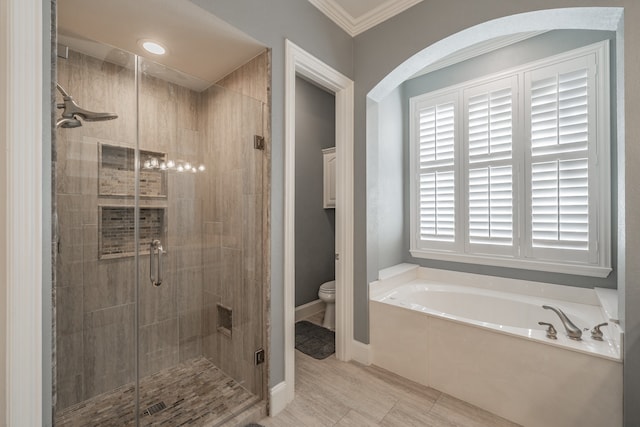 bathroom with ornamental molding, toilet, and separate shower and tub