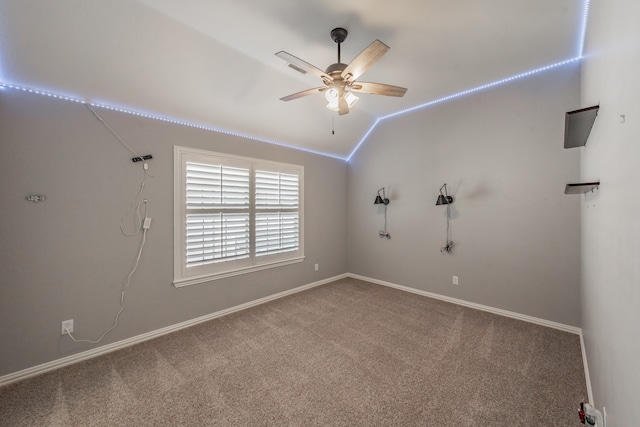 carpeted empty room with lofted ceiling and ceiling fan