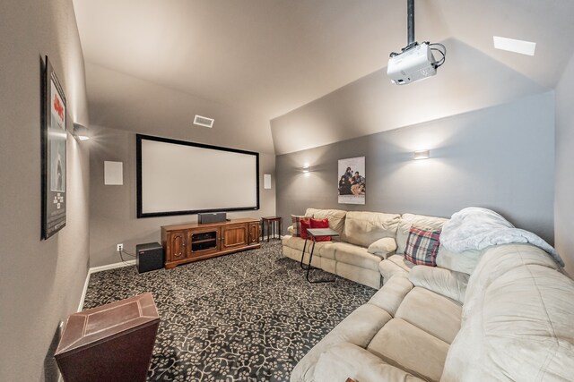 carpeted cinema room featuring lofted ceiling