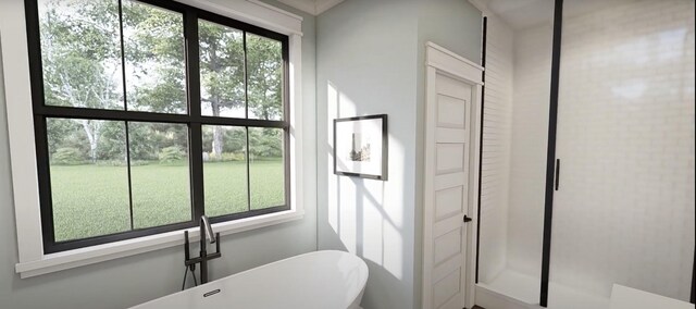 bathroom with plenty of natural light and independent shower and bath