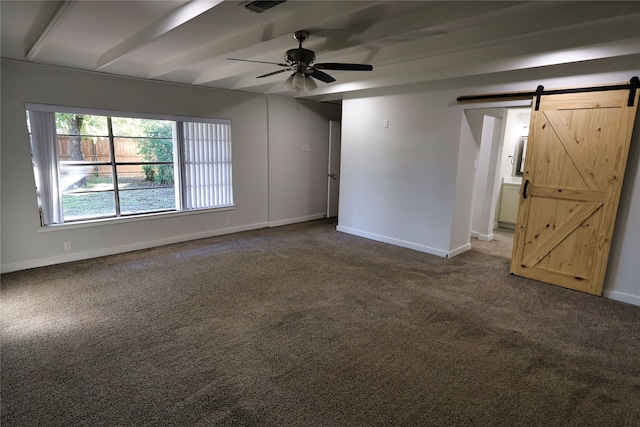 carpeted empty room featuring beam ceiling, a barn door, and ceiling fan