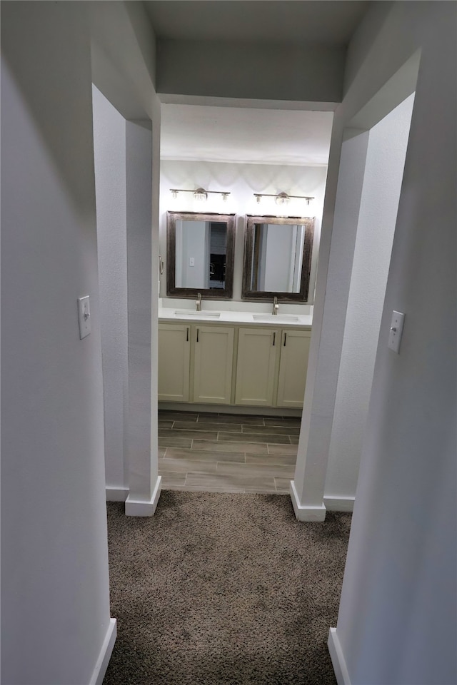 hall featuring sink and light hardwood / wood-style floors