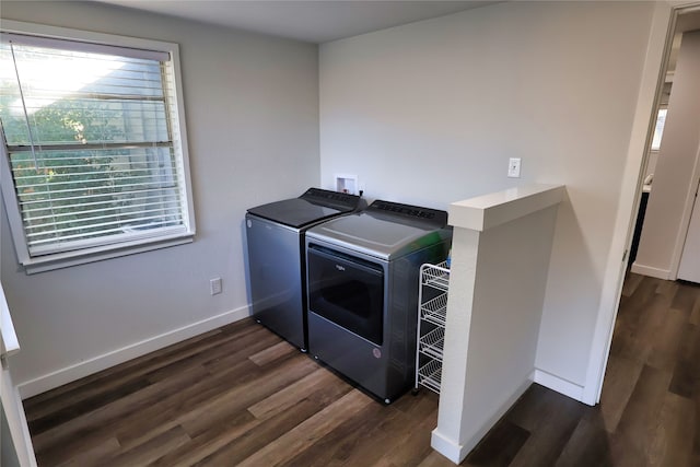 laundry room with dark hardwood / wood-style flooring and independent washer and dryer