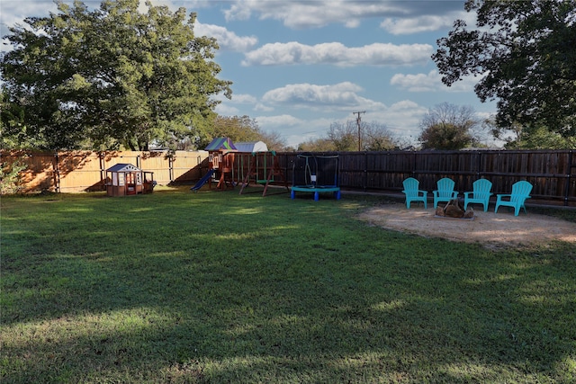 view of yard with a playground and a trampoline