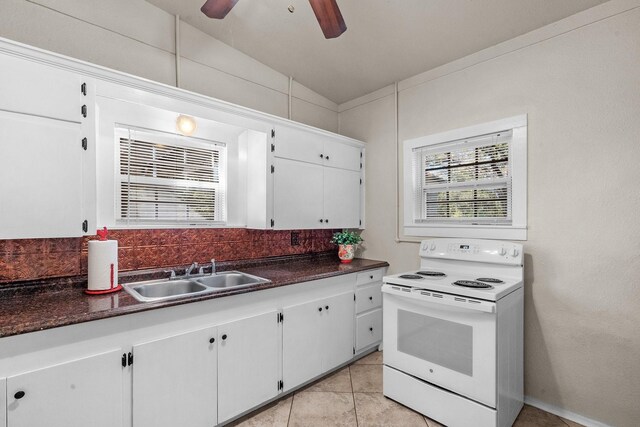 kitchen with white cabinets, sink, white electric stove, and vaulted ceiling