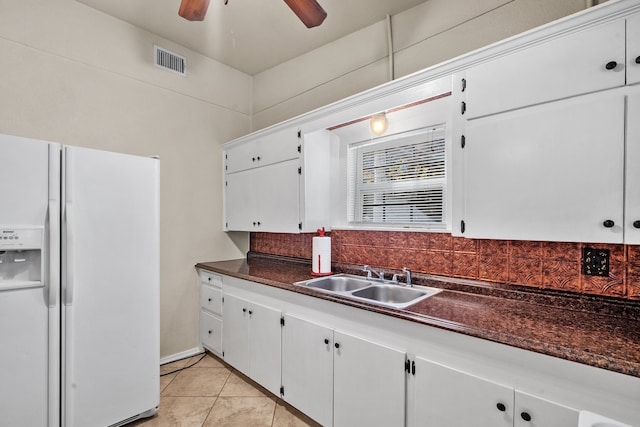 kitchen featuring white cabinetry, light tile patterned flooring, white fridge with ice dispenser, and sink