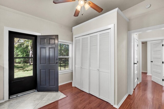 entryway featuring plenty of natural light, wood-type flooring, and ornamental molding