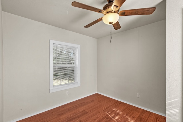 empty room with ceiling fan and wood-type flooring