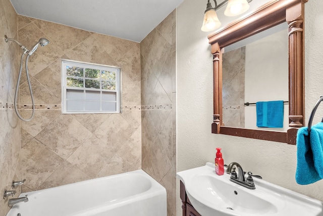 bathroom featuring vanity and tiled shower / bath