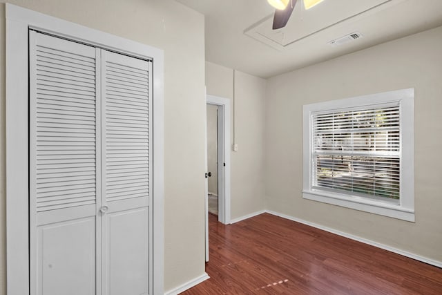 corridor with dark hardwood / wood-style flooring