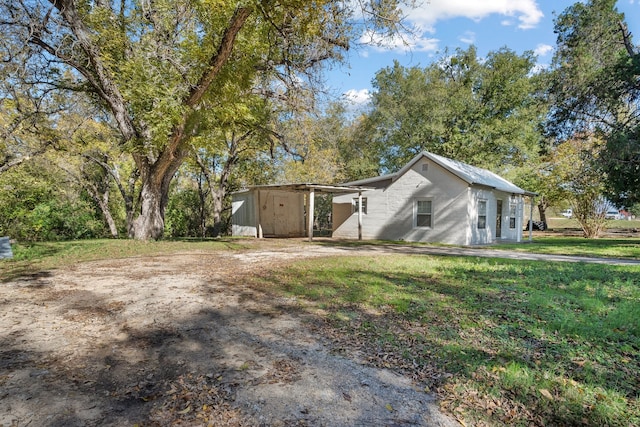 exterior space with a lawn and a storage shed