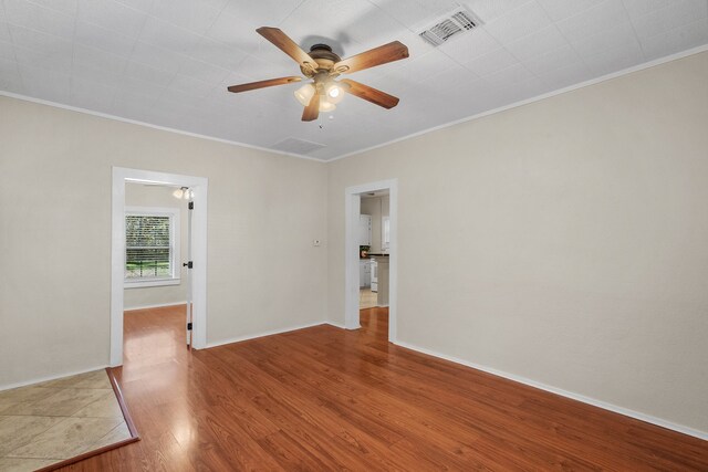 spare room featuring ceiling fan, ornamental molding, and hardwood / wood-style flooring