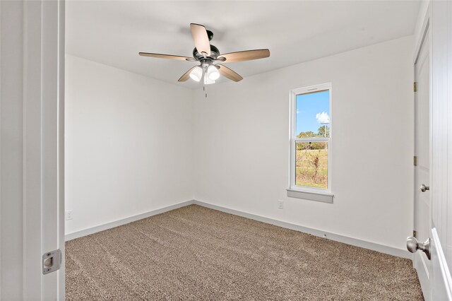 carpeted empty room with ceiling fan