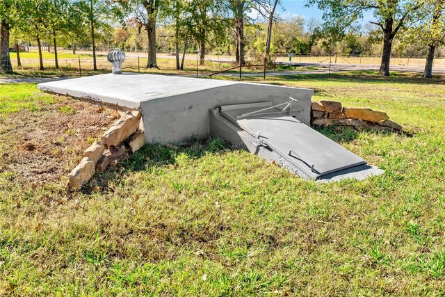 view of storm shelter with a lawn