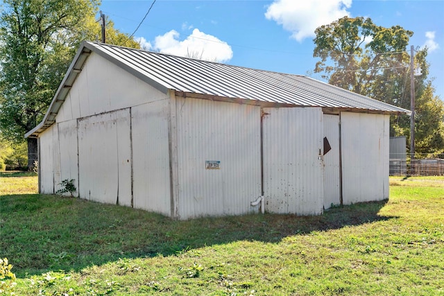 view of outbuilding featuring a lawn