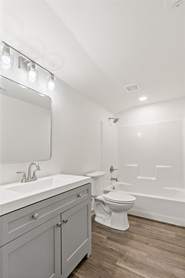 full bathroom with wood-type flooring, vanity, toilet, and shower / bathtub combination