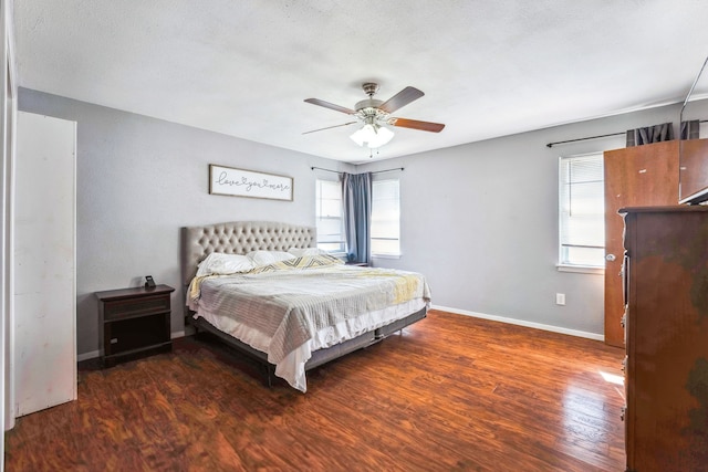 bedroom with a textured ceiling, dark hardwood / wood-style flooring, and ceiling fan