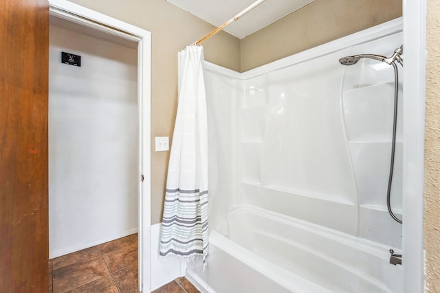 bathroom with tile patterned floors and shower / tub combo