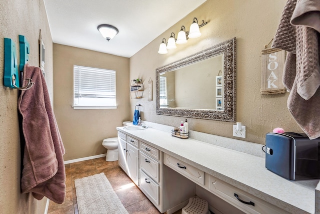 bathroom with tile patterned floors, vanity, and toilet