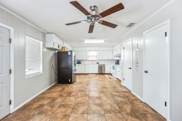 kitchen with white cabinets, ceiling fan, crown molding, and appliances with stainless steel finishes