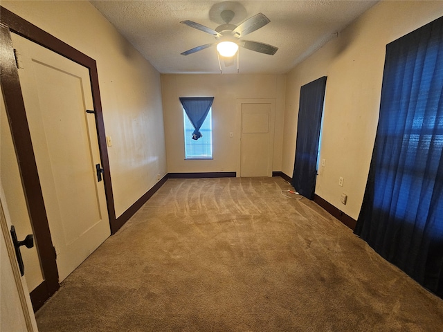 carpeted empty room with a textured ceiling and ceiling fan