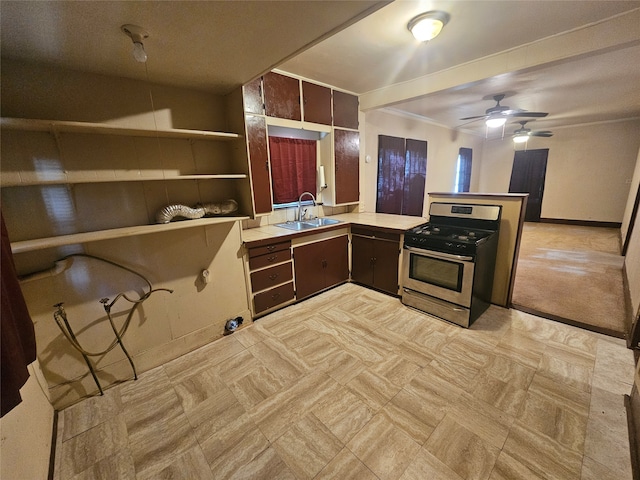 kitchen featuring ceiling fan, crown molding, sink, and stainless steel range with gas stovetop