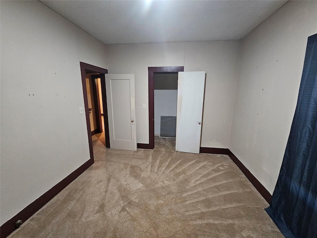 unfurnished bedroom with light colored carpet